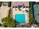 An aerial shot of a luxurious pool and spa with lounge chairs perfect for relaxation on a sunny day at 9580 High Gate Dr # 1822, Sarasota, FL 34238