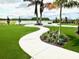 Artificial backyard lawn with a concrete walkway and views of the lake at 10006 Degas Ter, Bradenton, FL 34212