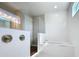 Beautiful soaking tub with tiled walls and window, creating a relaxing spa-like experience at 10006 Degas Ter, Bradenton, FL 34212