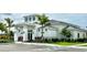 Community clubhouse showcases contemporary architecture, lush landscaping, and convenient parking at 10006 Degas Ter, Bradenton, FL 34212