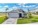 Beautiful single Gathering home with landscaped front yard, brick driveway, and attached two-car garage at 10006 Degas Ter, Bradenton, FL 34212