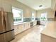 Spacious kitchen features modern appliances, tile backsplash, and bright natural light at 10006 Degas Ter, Bradenton, FL 34212