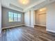 Spacious living area features wood-look floors, tray ceiling, and bright natural light at 10006 Degas Ter, Bradenton, FL 34212