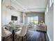 Bright open-concept living and dining room boasts stylish furnishings and access to the outdoors at 10006 Degas Ter, Bradenton, FL 34212