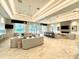 Expansive lounge area featuring modern furnishings, elegant lighting, and a cozy fireplace at 10006 Degas Ter, Bradenton, FL 34212