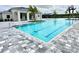 Community pool with clear blue water, gray tile accents, and nearby palm trees, offering a refreshing outdoor space at 10006 Degas Ter, Bradenton, FL 34212