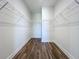 Spacious walk-in closet with wood flooring and white shelving perfect for storage and organization at 10006 Degas Ter, Bradenton, FL 34212