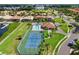 Community aerial featuring a pool, tennis courts, clubhouse, and waterfront access at 1009 3Rd E St, Palmetto, FL 34221