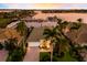 Aerial view of a well-maintained home near the marina with lush landscaping and vibrant sunset views at 1009 3Rd E St, Palmetto, FL 34221