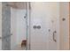 Modern bathroom featuring glass shower with rainfall showerhead and blue mosaic tile accent at 1009 3Rd E St, Palmetto, FL 34221
