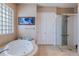 Well-lit bathroom with a jacuzzi tub, walk-in shower, and tiled flooring at 1009 3Rd E St, Palmetto, FL 34221