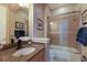 Bathroom features a granite countertop, sink, shower with glass doors, and tiled floors at 1009 3Rd E St, Palmetto, FL 34221