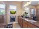 Well-lit bathroom featuring double sinks, granite countertops, and a walk-in glass shower at 1009 3Rd E St, Palmetto, FL 34221