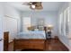 Cozy bedroom showcasing a wooden bed frame, neutral bedding, and bright natural light at 1009 3Rd E St, Palmetto, FL 34221