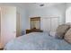 Bright bedroom featuring a comfortable bed, mirrored dresser, and spacious closet at 1009 3Rd E St, Palmetto, FL 34221