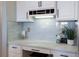 Custom desk area with white cabinets, modern lighting, and stylish countertops at 1009 3Rd E St, Palmetto, FL 34221