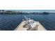 White Adirondack chairs sit at the end of a private dock with panoramic views of the surrounding boats and water at 1009 3Rd E St, Palmetto, FL 34221