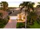 Beautiful waterfront home with a brick driveway, lush landscaping and two-car garage at 1009 3Rd E St, Palmetto, FL 34221