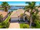 Stunning waterfront home with lush landscaping, brick driveway, and private boat docks in a tropical paradise at 1009 3Rd E St, Palmetto, FL 34221