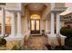 Inviting front entrance with large columns, brick pavers, and double doors with glass details at 1009 3Rd E St, Palmetto, FL 34221