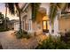 Elegant front entrance with arched doorway, brick pathway, and lush landscaping at 1009 3Rd E St, Palmetto, FL 34221