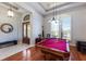 Elegant game room featuring a pool table, tiled flooring, and ample natural light at 1009 3Rd E St, Palmetto, FL 34221