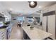 Bright kitchen featuring white cabinets, marble countertops, and an island with views of the canal and pool at 1009 3Rd E St, Palmetto, FL 34221