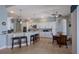 Bright kitchen with white cabinets, marble countertops, a stylish island with barstools, and stainless steel appliances at 1009 3Rd E St, Palmetto, FL 34221