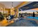 Covered lanai with comfortable seating, a ceiling fan, and views of the waterfront and gorgeous sunset at 1009 3Rd E St, Palmetto, FL 34221