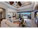 Elegant living room with tile floors, comfortable sofa, and sliding glass doors to the lanai and scenic waterfront at 1009 3Rd E St, Palmetto, FL 34221