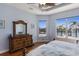 Main bedroom with wood floors, tray ceiling, canal views, and a decorative dresser at 1009 3Rd E St, Palmetto, FL 34221