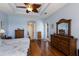 Spacious bedroom with wood floors, a tray ceiling, and elegant wooden furniture at 1009 3Rd E St, Palmetto, FL 34221