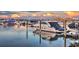 Beautiful waterfront view of a sleek boat docked in the marina, reflecting the sunset, sky, and surrounding residences at 1009 3Rd E St, Palmetto, FL 34221