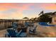 Picturesque outdoor patio with comfortable seating, a cozy fire pit, and stunning waterfront and sunset views at 1009 3Rd E St, Palmetto, FL 34221