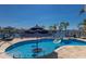 Gorgeous waterfront pool with a swim up table and chairs and palm trees at 1009 3Rd E St, Palmetto, FL 34221