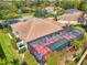 Aerial view of a beautiful backyard, featuring a screened-in pool and lush green landscaping at 107 Wayforest Dr, Venice, FL 34292