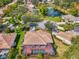 Beautiful aerial view showcasing the home's screened-in pool and the peaceful neighborhood pond at 107 Wayforest Dr, Venice, FL 34292