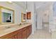 Beautiful primary bathroom with double sinks, granite countertops, and soaking tub at 107 Wayforest Dr, Venice, FL 34292