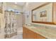Bathroom vanity area with framed mirror and granite countertop at 107 Wayforest Dr, Venice, FL 34292
