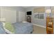 Well-lit bedroom with natural light from the window, TV, and closets at 107 Wayforest Dr, Venice, FL 34292