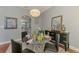 Elegant dining area with a glass table, black buffet, and hardwood floors at 107 Wayforest Dr, Venice, FL 34292
