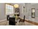 Bright dining area featuring a glass table, stylish chairs, and elegant decor at 107 Wayforest Dr, Venice, FL 34292