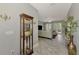Inviting hallway with tile floors leading to a bright living room with French doors at 107 Wayforest Dr, Venice, FL 34292