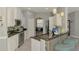 Open kitchen boasts stainless steel appliances, breakfast bar with seating, and access to the dining area at 107 Wayforest Dr, Venice, FL 34292