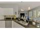 Kitchen features an eat-at bar, stainless steel appliances and opens up to the Gathering room for easy entertaining at 107 Wayforest Dr, Venice, FL 34292