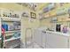 Laundry room with shelving, organized storage bins, washer, and dryer at 107 Wayforest Dr, Venice, FL 34292