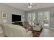Comfortable living room featuring plush seating, a ceiling fan, and French doors at 107 Wayforest Dr, Venice, FL 34292