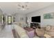 Inviting living area with tile floors, cozy seating, and front door access at 107 Wayforest Dr, Venice, FL 34292