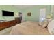 Bright main bedroom with natural light, neutral tones, and furniture for ample storage at 107 Wayforest Dr, Venice, FL 34292