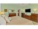 Stylish main bedroom with natural light, neutral tones, and furniture for ample storage at 107 Wayforest Dr, Venice, FL 34292